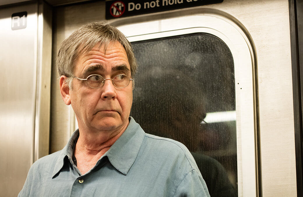 photograph of man looking at beggar in subway